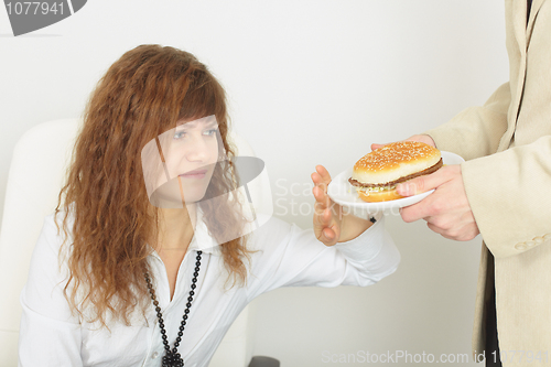 Image of Young beautiful woman refuses harmful food