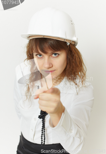 Image of Beautiful girl - engineer under safety precautions in helmet