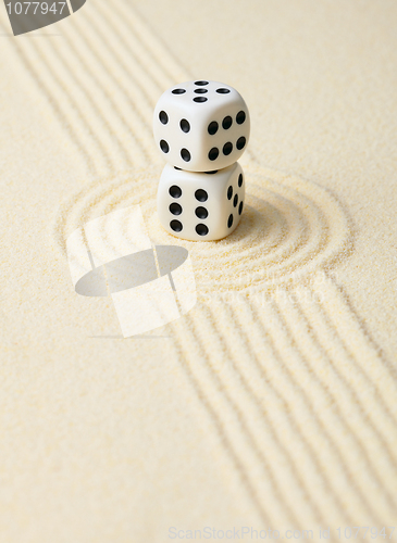 Image of Dices on sand in rock garden