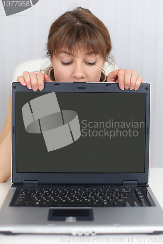 Image of Woman and blank screen of laptop