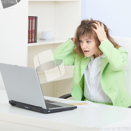 Image of Person in shock working in Internet with the laptop