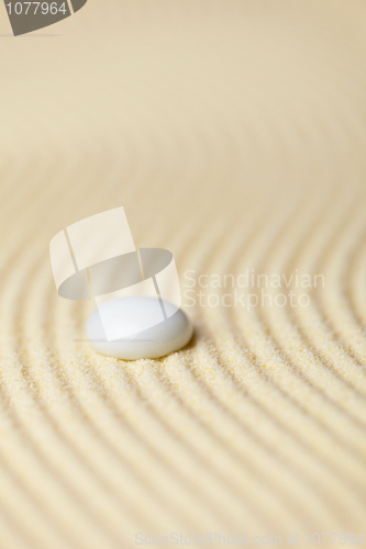 Image of White drop on surface of yellow sand