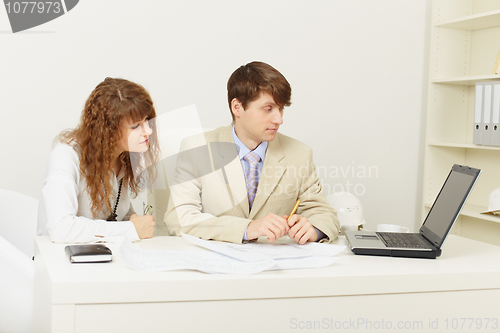 Image of Pair of young businessmen work at office