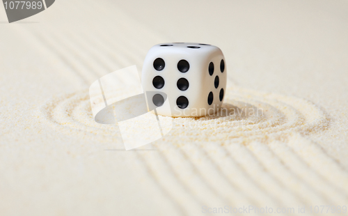 Image of Dice on sand in rock garden