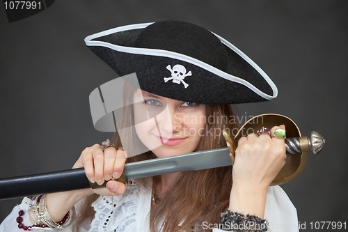 Image of Young woman pirate gets a sabre from sheath