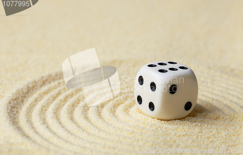 Image of Dice with against yellow sand