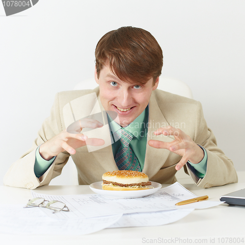 Image of Happy person is going to eat on workplace