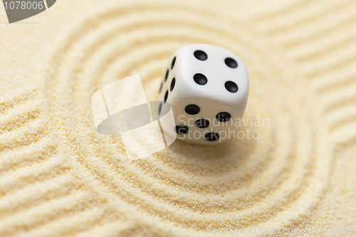 Image of Dice on sand surface - abstract art composition