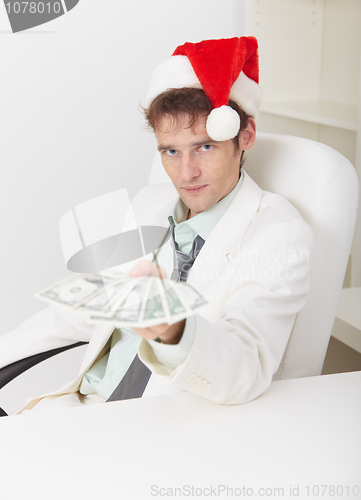 Image of Man in Christmas hat gives us money