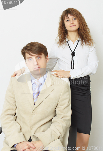 Image of Serious man in jacket and tie and woman