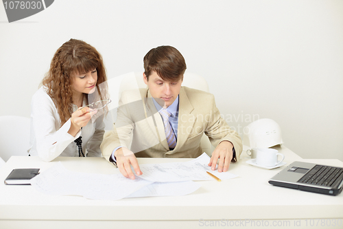 Image of Young engineers plan work sitting at a table