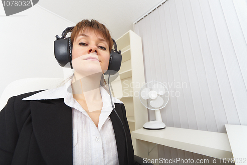 Image of Haughty woman - producer with ear-phones