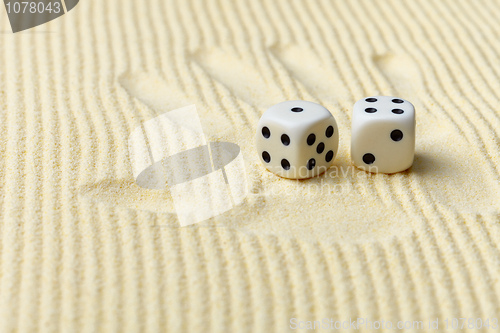 Image of Dices on sand surface and palm print - art composition