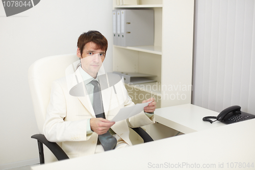 Image of Young businessman sits in the study