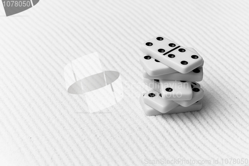 Image of Dominoes against sand