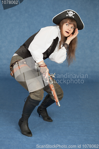 Image of Scared woman in suit of sea pirate on dark blue background
