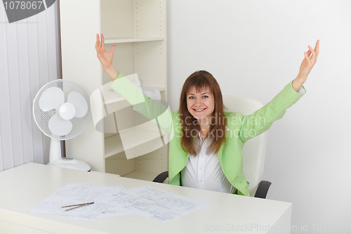 Image of Exulting girl at office on workplace