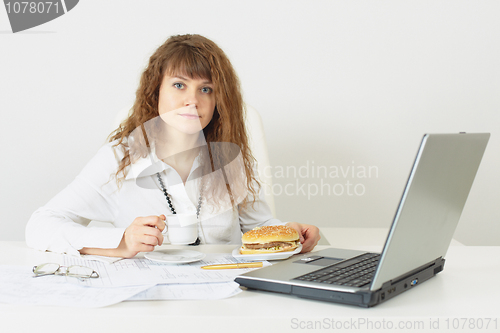 Image of Woman is going to have dinner a hamburger at office