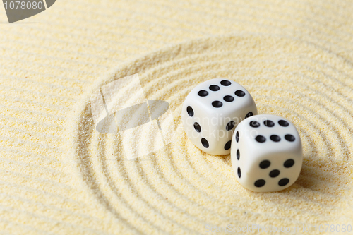 Image of Dices on sand surface - abstract art composition