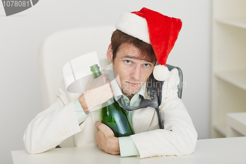 Image of Young drunkard celebrates new year at office