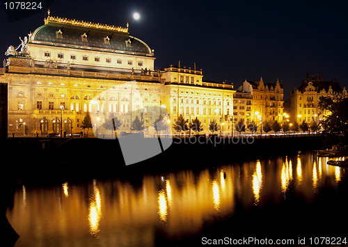 Image of A golden cover over Prague's National Theater along the Vitave river.