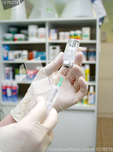 Image of syringe that is being filled with vaccine