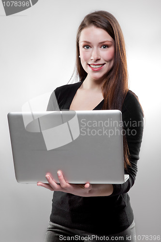 Image of Businesswoman holding a laptop