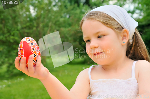 Image of Little girl holding Easter egg