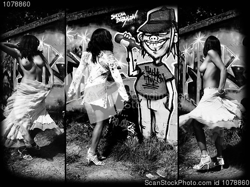 Image of Topless dancer in front of a graffiti.