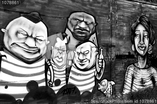 Image of Graffiti with a group of disturbing individuals.