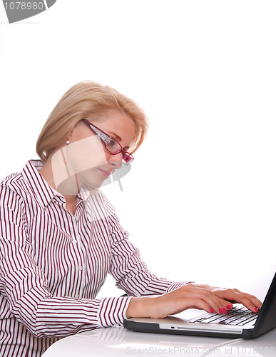 Image of young business woman using laptop at work desk