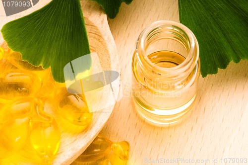 Image of ginko biloba essential oil with fresh leaves - beauty treatment