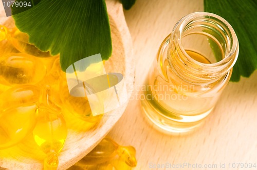 Image of ginko biloba essential oil with fresh leaves - beauty treatment