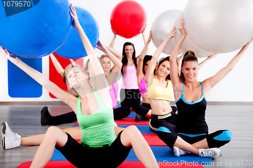 Image of people doing stretching exercise with fitness balls