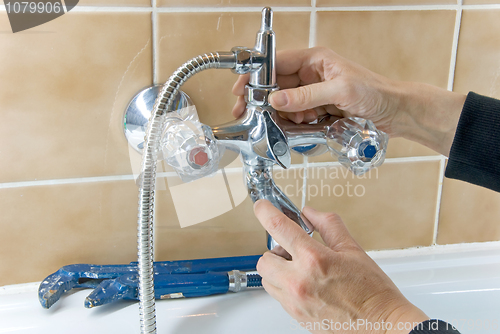 Image of plumber and tap