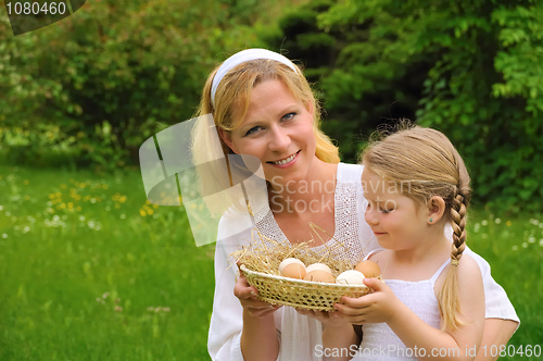 Image of Mother and daughter holding fresh eggs