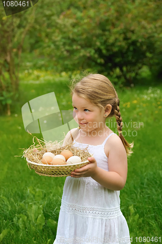 Image of Little girl holding fresh eggs