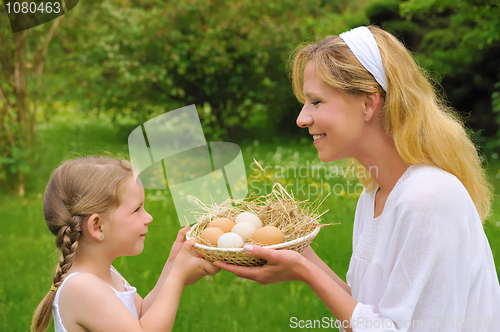 Image of Mother and daughter holding fresh eggs