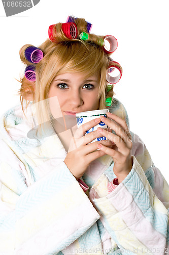 Image of funny housewife with curlers and cup 