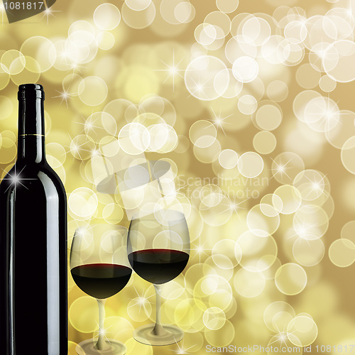 Image of Red Wine Bottle and Two Glasses Bokeh Background