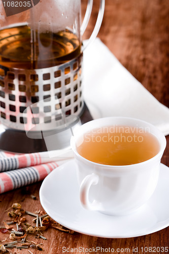 Image of french press and cup of fresh herbal tea 