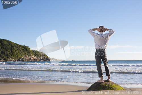 Image of Businessman relaxing on a beach