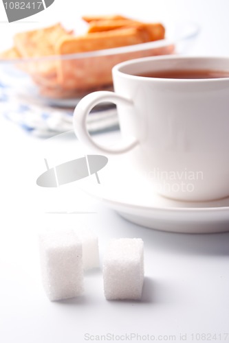 Image of cup of tea, sugar and cookies