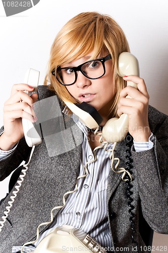 Image of businesswoman with three phones 