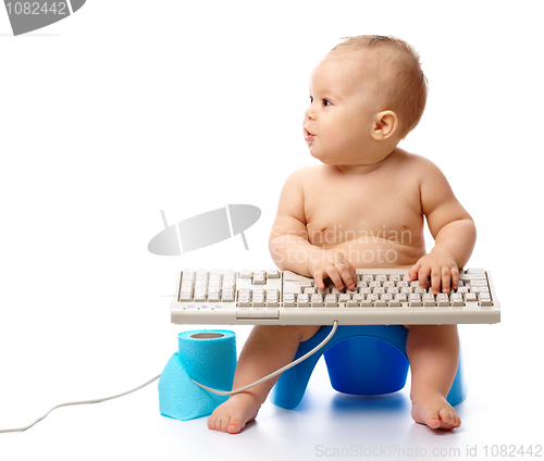 Image of Little child is typing on keyboard