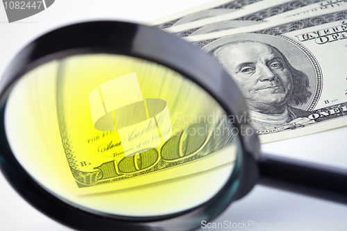 Image of Dollars under a magnifying glass