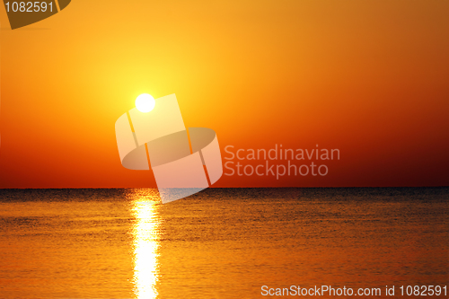 Image of landscape with sunrise over sea