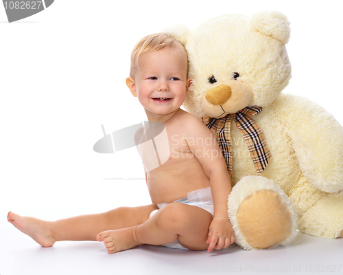 Image of Happy child with big soft bear toy