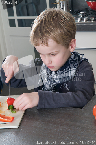 Image of Boy cutting pepper