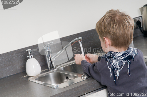 Image of Child washing his hands